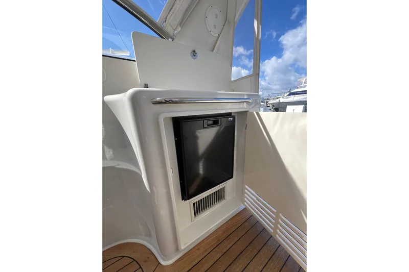 Split Decision Yacht Photos Pics 2007 Chris-Craft Roamer 40 yacht interior with built-in mini fridge and wooden flooring.