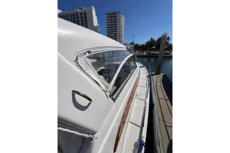 Split Decision Yacht Photos Pics 2007 Chris-Craft Roamer 40 yacht docked, showcasing sleek design and clear blue sky.