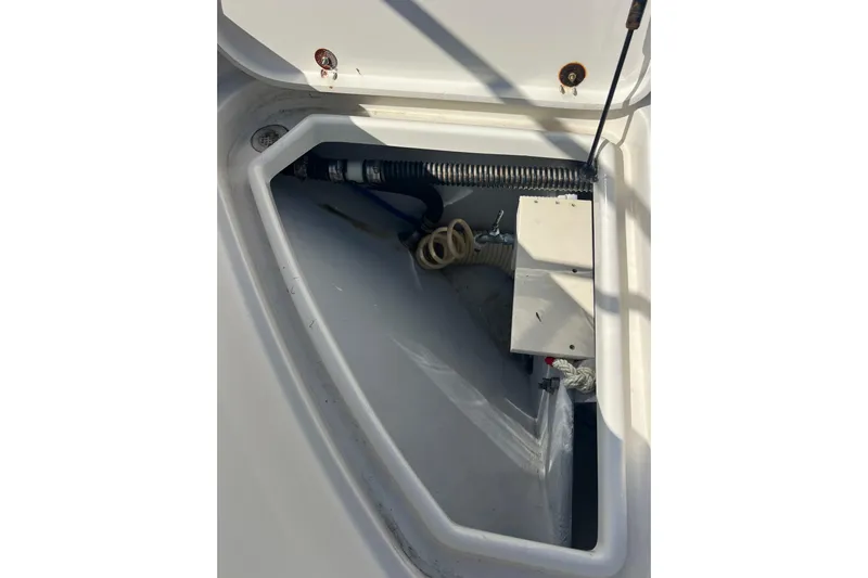 Split Decision Yacht Photos Pics Storage compartment of 2007 Chris-Craft Roamer 40 boat, featuring hoses and equipment.