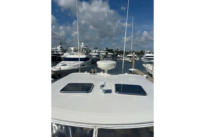 Split Decision Yacht Photos Pics 2007 Chris-Craft Roamer 40 yacht docked at marina under cloudy sky.