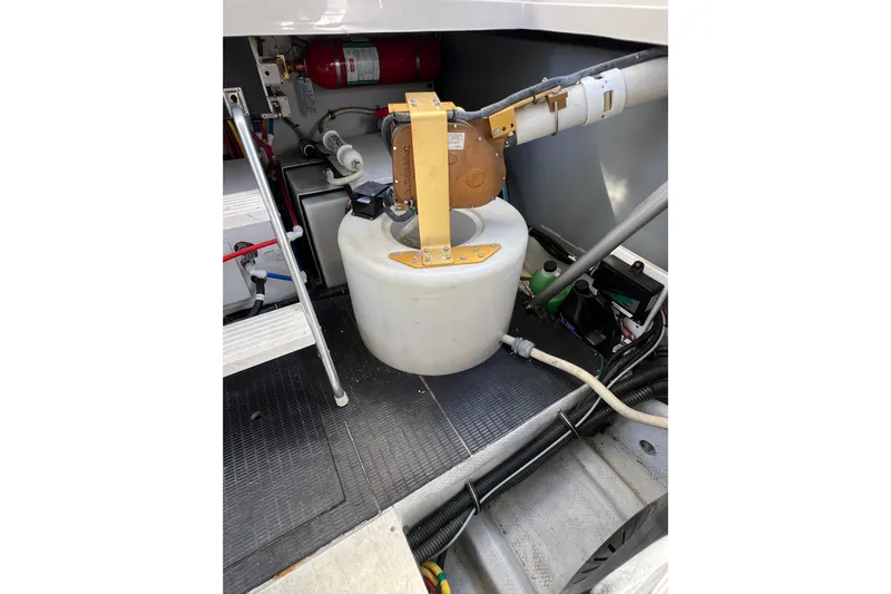 Split Decision Yacht Photos Pics Engine room of 2007 Chris-Craft Roamer 40 with equipment and fire extinguisher.