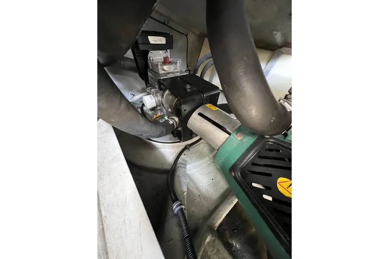 Split Decision Yacht Photos Pics Engine compartment of 2007 Chris-Craft Roamer 40, showcasing mechanical components and hoses.