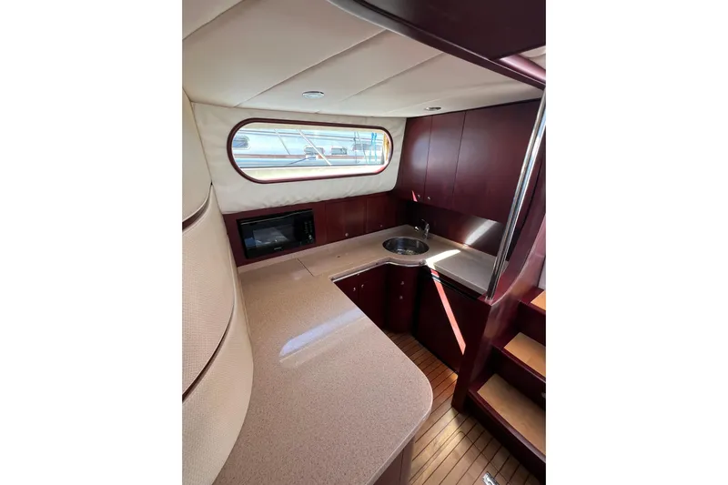 Split Decision Yacht Photos Pics Luxurious 2007 Chris-Craft Roamer 40 yacht interior with modern kitchen and wood accents.