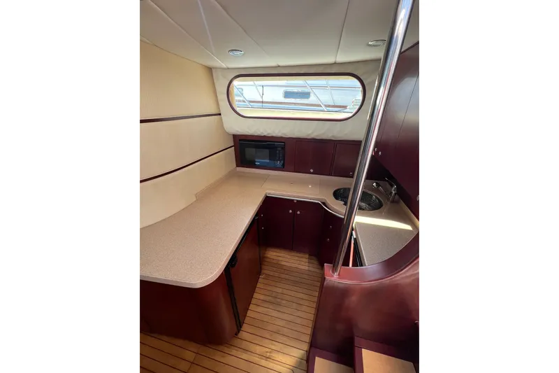 Split Decision Yacht Photos Pics Luxurious 2007 Chris-Craft Roamer 40 yacht interior with modern kitchen and wood flooring.