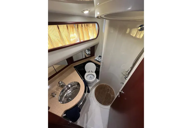 Split Decision Yacht Photos Pics Luxurious bathroom in 2007 Chris-Craft Roamer 40 yacht with modern fixtures and elegant design.