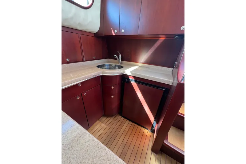 Split Decision Yacht Photos Pics Luxurious 2007 Chris-Craft Roamer 40 yacht kitchen with wood cabinetry and compact design.