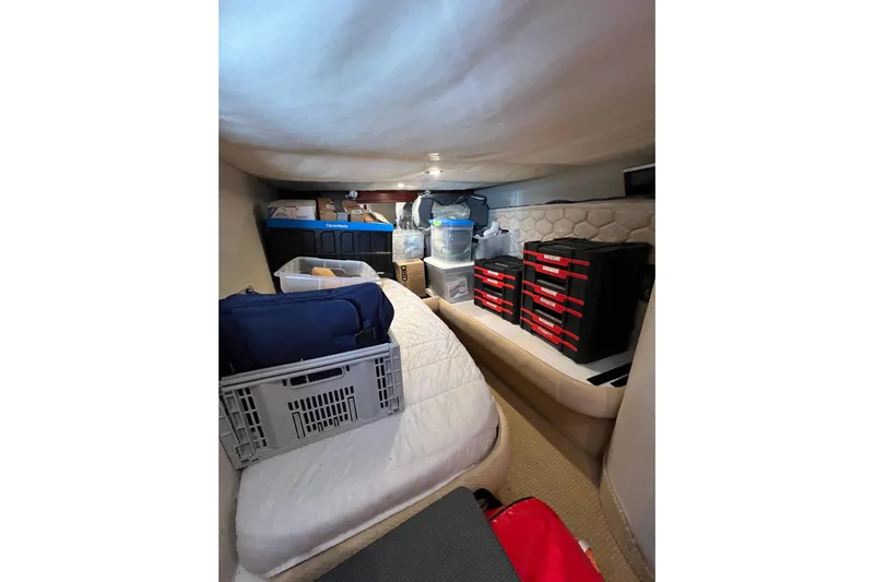 Split Decision Yacht Photos Pics Interior storage area of 2007 Chris-Craft Roamer 40, featuring organized containers and supplies.
