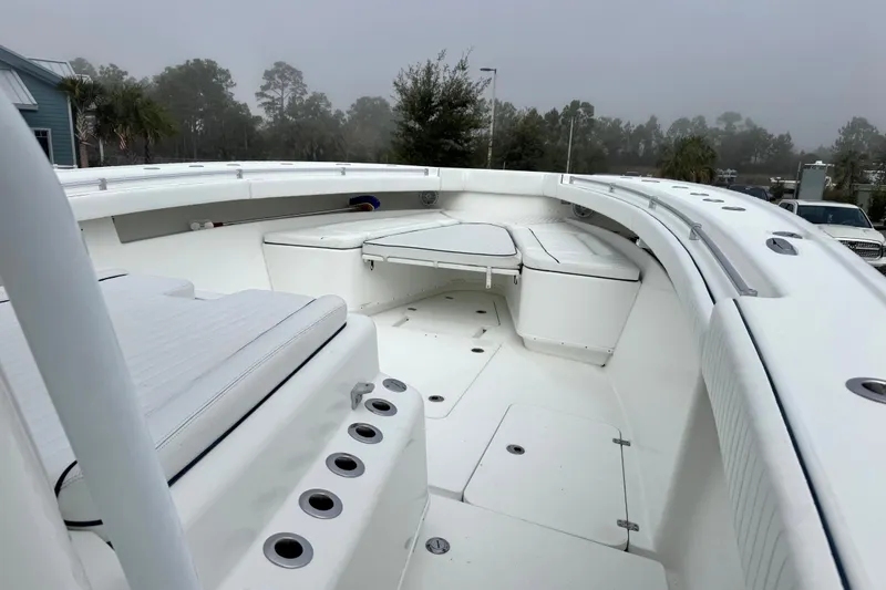  Yacht Photos Pics 2011 Yellowfin 42 Offshore boat interior with white seating and rod holders.