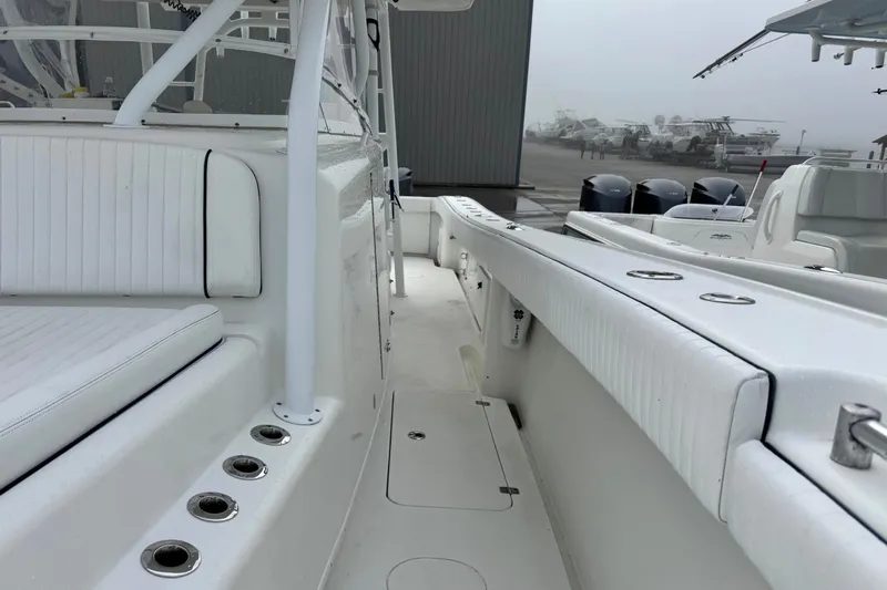  Yacht Photos Pics 2011 Yellowfin 42 Offshore boat interior with white seating and rod holders.