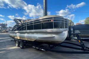 2013 Bennington R22 pontoon boat on trailer under a blue sky with clouds.