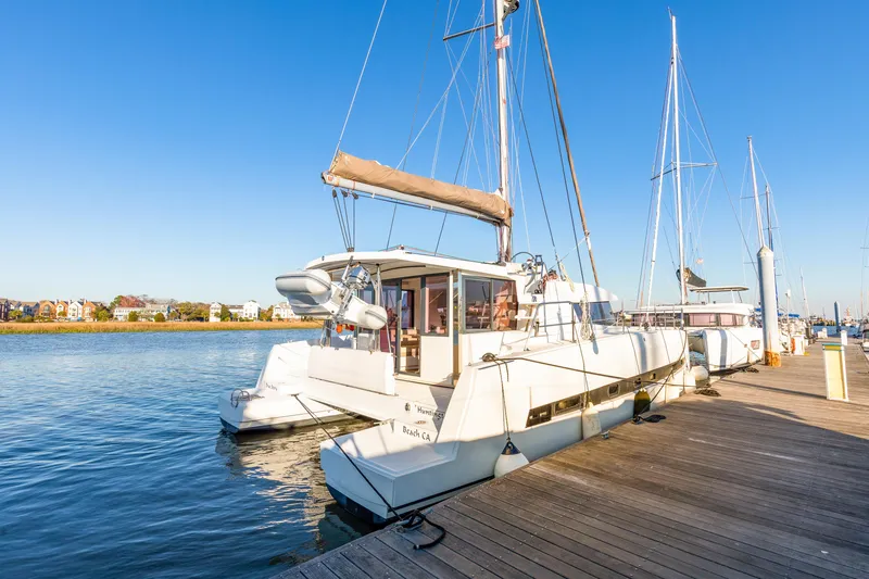 Chasing Shimmer Yacht Photos Pics 2018 Bali 4.0 catamaran docked at a marina under clear blue skies.