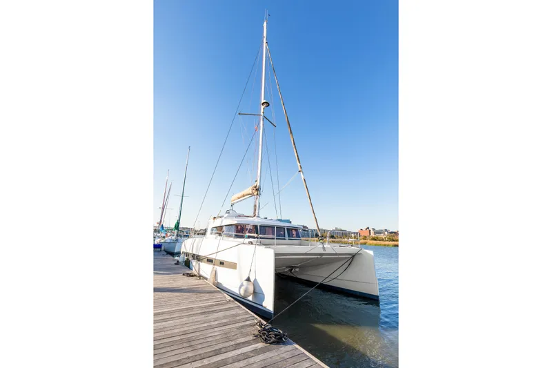 Chasing Shimmer Yacht Photos Pics 2018 Bali 4.0 catamaran docked at a marina under clear blue skies.