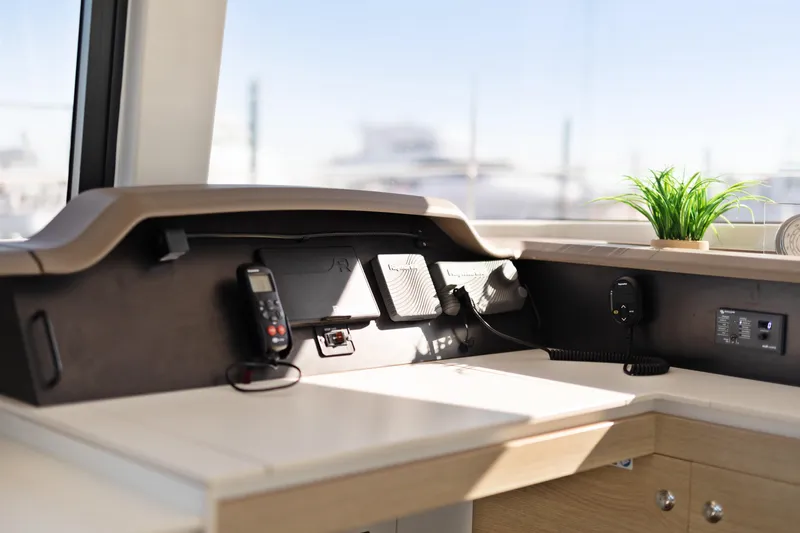 Chasing Shimmer Yacht Photos Pics Modern navigation station on 2018 Bali 4.0 yacht with communication devices and plant.