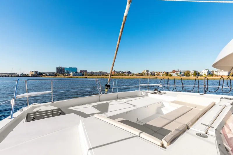 Chasing Shimmer Yacht Photos Pics Deck view of 2018 Bali 4.0 catamaran with waterfront cityscape in background.