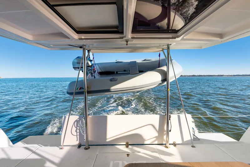 Chasing Shimmer Yacht Photos Pics Bali 4.0 catamaran with dinghy on ocean, 2018 model, rear view.