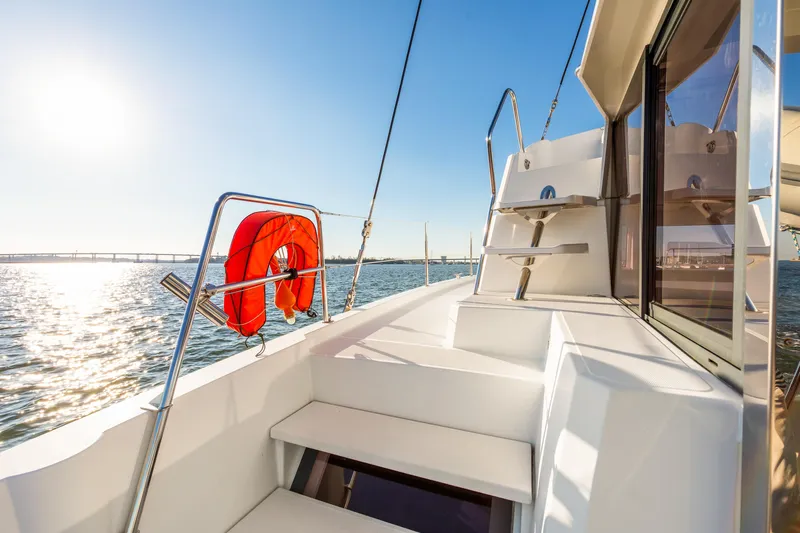 Chasing Shimmer Yacht Photos Pics Bali 4.0 catamaran deck with lifebuoy, ocean view, and sunny sky, 2018 model.