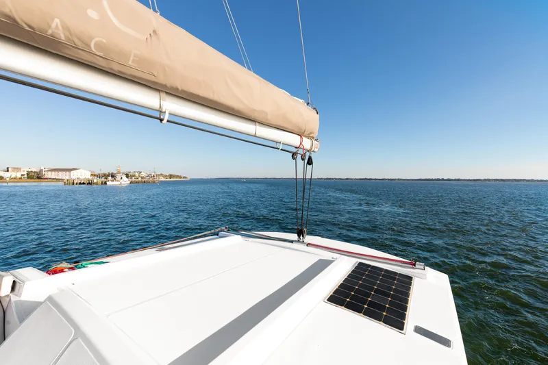 Chasing Shimmer Yacht Photos Pics Sailing on a 2018 Bali 4.0 catamaran with solar panel, clear blue sky, and ocean view.