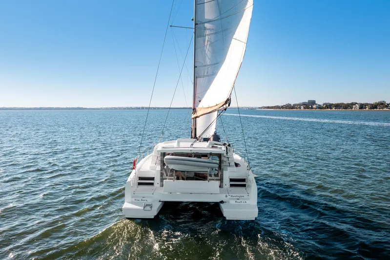 Chasing Shimmer Yacht Photos Pics Sailing catamaran Bali 4.0, 2018 model, cruising on open water under clear blue sky.