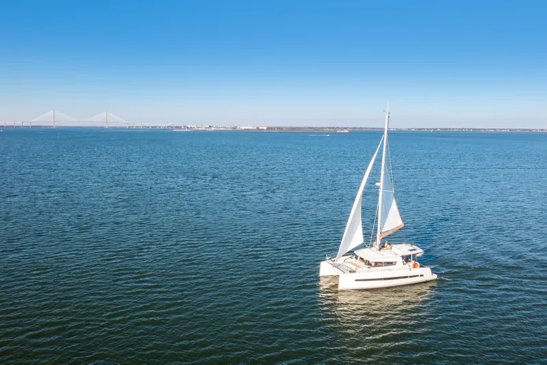 Chasing Shimmer Yacht Photos Pics Sailing catamaran Bali 4.0, 2018 model, on open sea with clear blue sky.