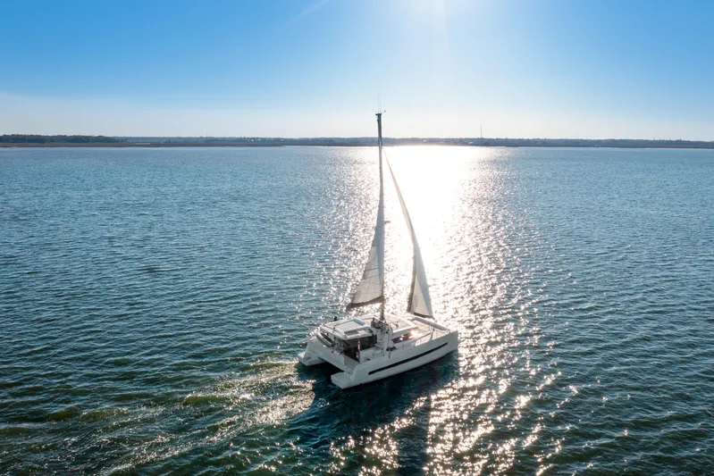 Chasing Shimmer Yacht Photos Pics Sailing catamaran Bali 4.0 (2018) on open water under clear blue sky.