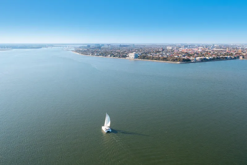 Chasing Shimmer Yacht Photos Pics Sailboat on open water near city coastline, Bali 4.0 model, 2018.