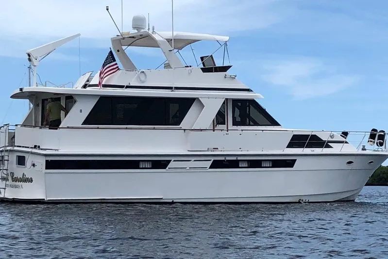 Sweet Caroline Yacht Photos Pics 1989 Jefferson Marquessa 52 yacht on water, featuring sleek design and American flag.