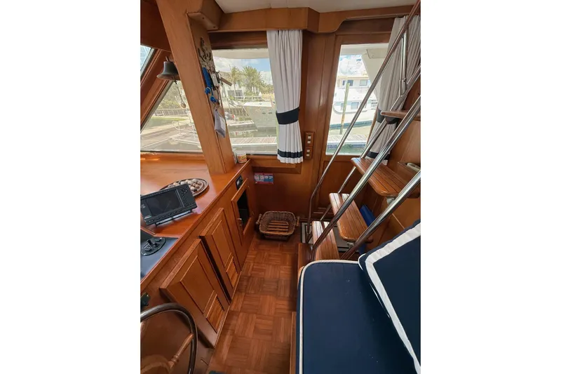 Sweet Caroline Yacht Photos Pics Interior of 1989 Jefferson Marquessa 52 yacht with wooden finishes and nautical decor.