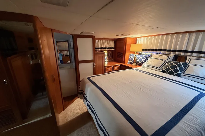 Sweet Caroline Yacht Photos Pics Luxurious bedroom interior of 1989 Jefferson Marquessa 52 yacht with elegant bedding.