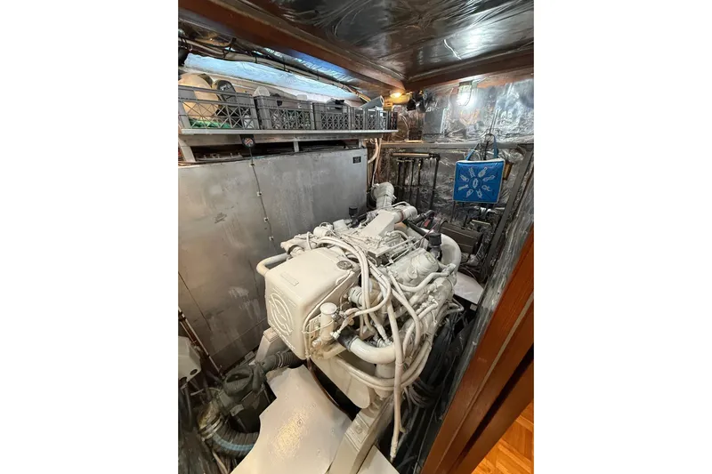 Sweet Caroline Yacht Photos Pics Engine room of 1989 Jefferson Marquessa 52 yacht, showcasing machinery and equipment.