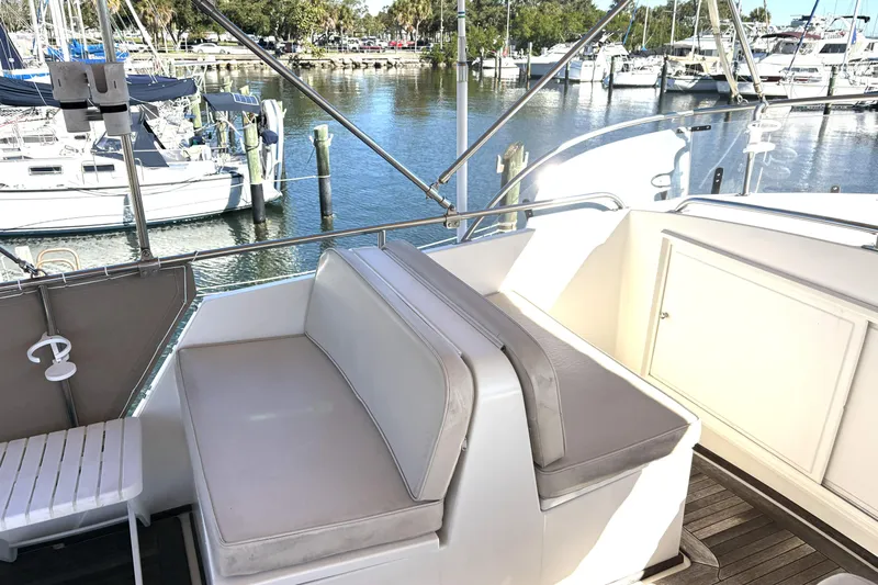 Deja Vu Yacht Photos Pics Flybridge seating on a 1993 Grand Banks 42 Classic yacht, overlooking a marina.