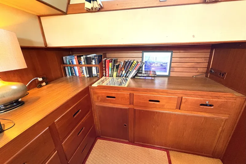 Deja Vu Yacht Photos Pics Cozy wooden interior of 1993 Grand Banks 42 Classic with books and framed photo.