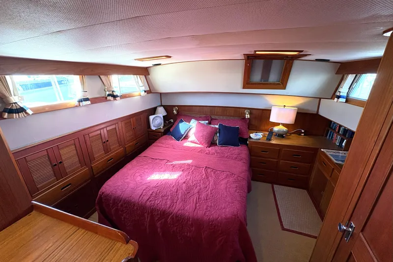 Deja Vu Yacht Photos Pics Cozy bedroom interior of 1993 Grand Banks 42 Classic yacht with wood furnishings.