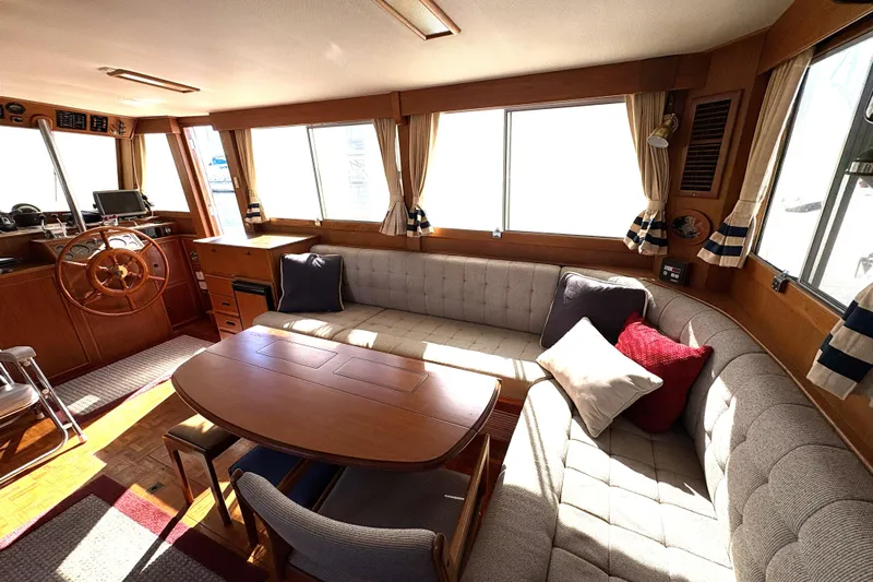 Deja Vu Yacht Photos Pics Interior of 1993 Grand Banks 42 Classic yacht with cozy seating and wooden helm.