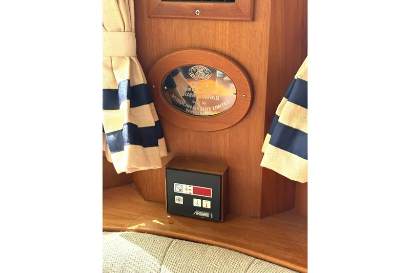 Deja Vu Yacht Photos Pics Plaque on 1993 Grand Banks 42 Classic yacht interior with striped curtains.