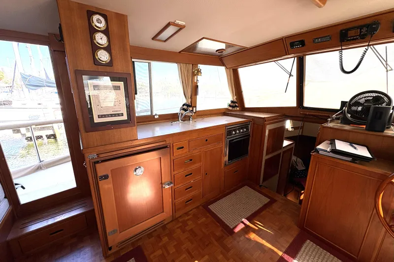 Deja Vu Yacht Photos Pics 1993 Grand Banks 42 Classic yacht interior with wooden cabinetry and nautical instruments.