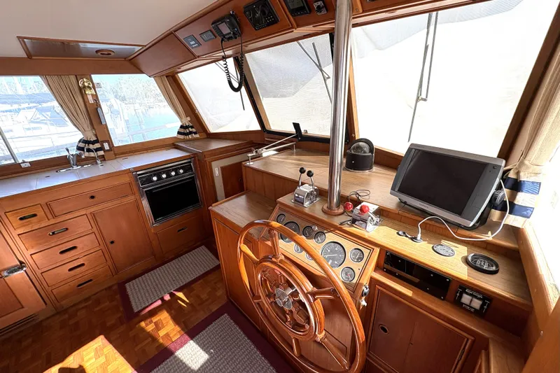 Deja Vu Yacht Photos Pics Interior of 1993 Grand Banks 42 Classic yacht with wooden helm and navigation equipment.