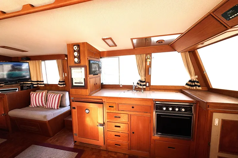 Deja Vu Yacht Photos Pics Interior of 1993 Grand Banks 42 Classic yacht with wood cabinetry and cozy seating area.
