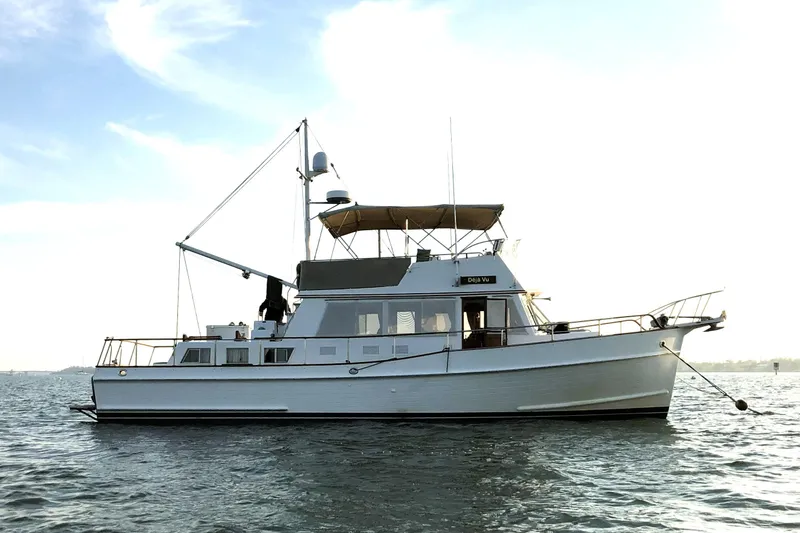 Deja Vu Yacht Photos Pics 1993 Grand Banks 42 Classic yacht on calm water, side view.