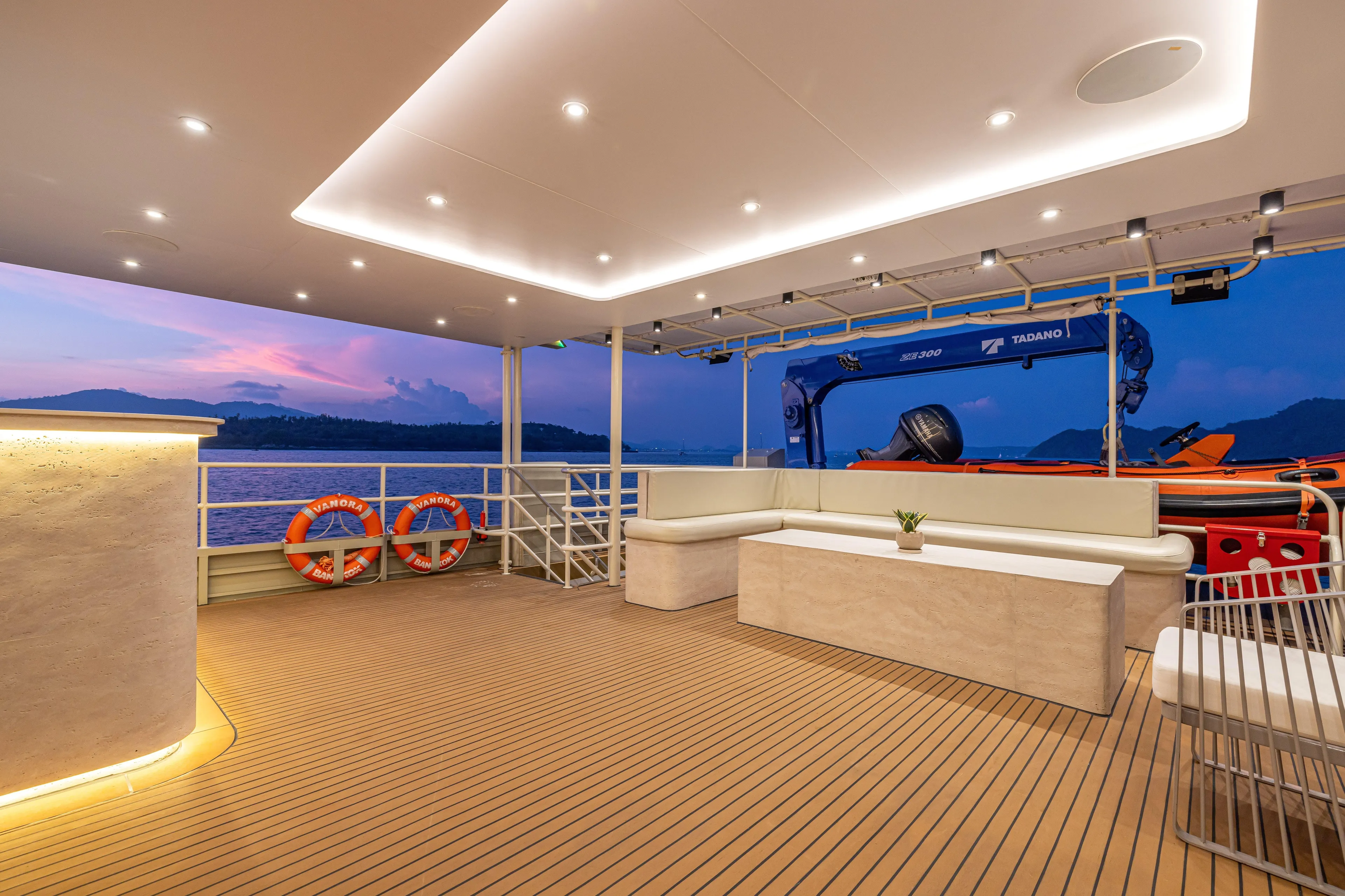 Vanora Yacht Photos Pics Luxurious Seacrest Marine 52m Yacht deck at sunset, featuring modern seating and lifebuoys, 2023 model.