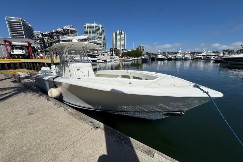  Yacht Photos Pics 2014 SeaVee 340B Open boat docked at a marina with city skyline.