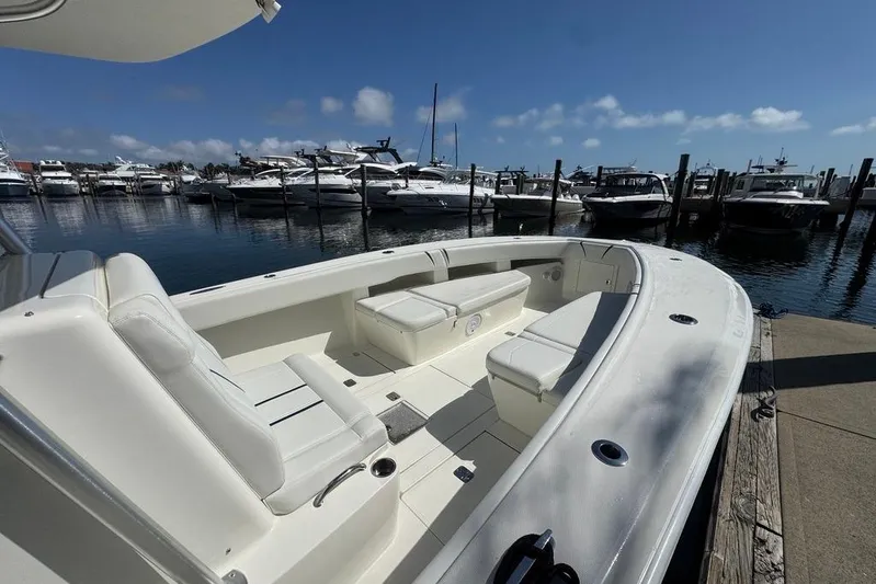  Yacht Photos Pics 2014 SeaVee 340B Open boat docked at marina, featuring spacious seating and clear skies.