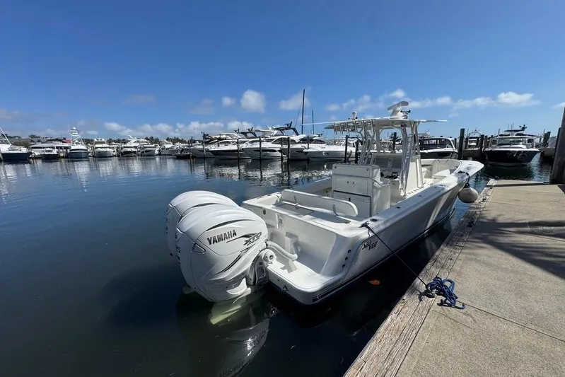  Yacht Photos Pics 2014 SeaVee 340B Open boat docked with Yamaha engines, clear sky, marina background.
