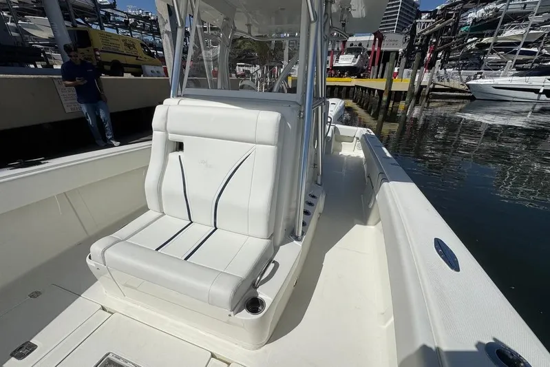  Yacht Photos Pics 2014 SeaVee 340B Open boat with white seating, docked at a marina.