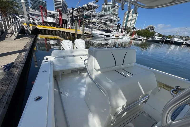  Yacht Photos Pics 2014 SeaVee 340B Open boat docked at marina with cityscape background.