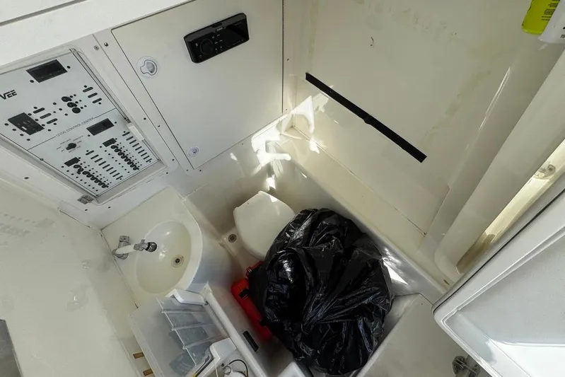  Yacht Photos Pics 2014 SeaVee 340B Open boat interior with control panel, sink, and storage area.