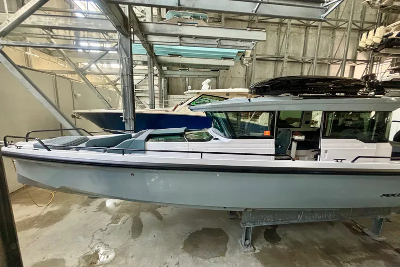  Yacht Photos Pics 2024 Axopar 37 XC Cross Cabin boat in indoor storage facility.