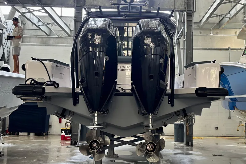  Yacht Photos Pics 2024 Axopar 37 XC Cross Cabin with dual outboard engines in a boatyard.