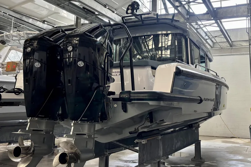  Yacht Photos Pics 2024 Axopar 37 XC Cross Cabin with dual outboard engines in a boatyard.