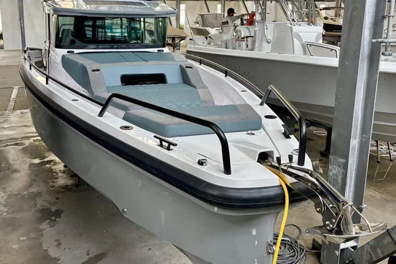  Yacht Photos Pics 2024 Axopar 37 XC Cross Cabin boat in a marina setting.