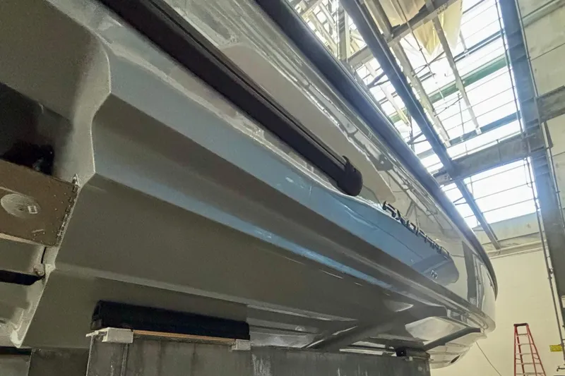  Yacht Photos Pics 2024 Axopar 37 XC Cross Cabin boat hull in a workshop setting.